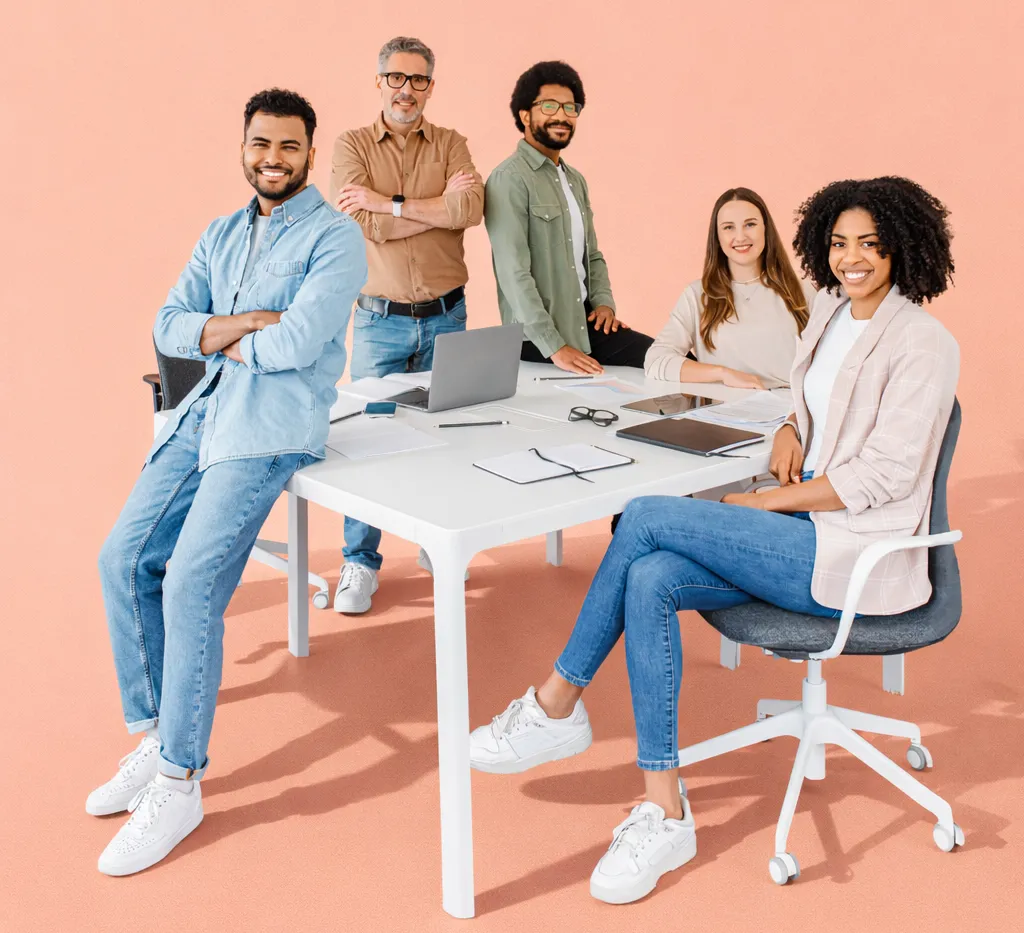 Team standing and seated around a white meeting table