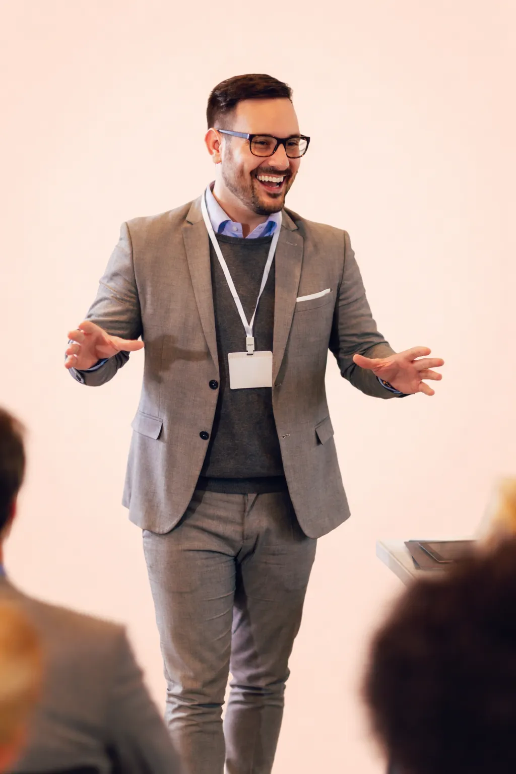 Speaker giving a keynote with a lanyard badge