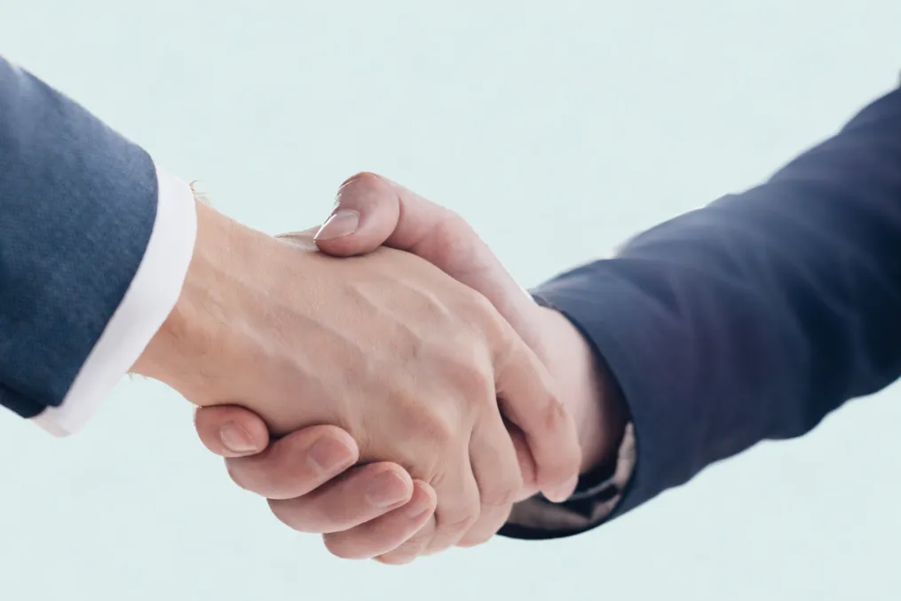 Close-up of two people shaking hands