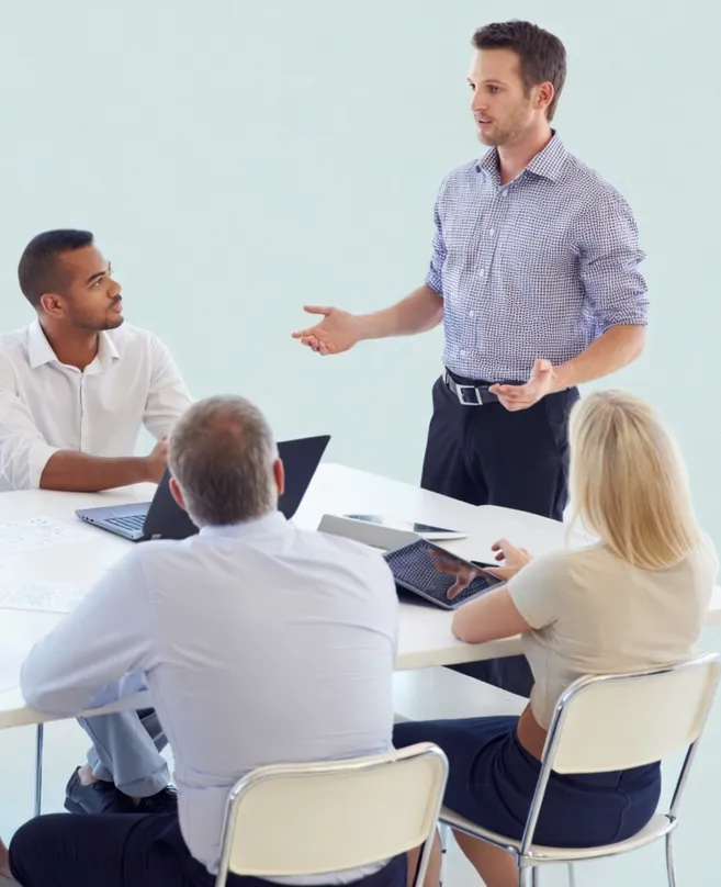 Founder presenting to a small group seated around a table