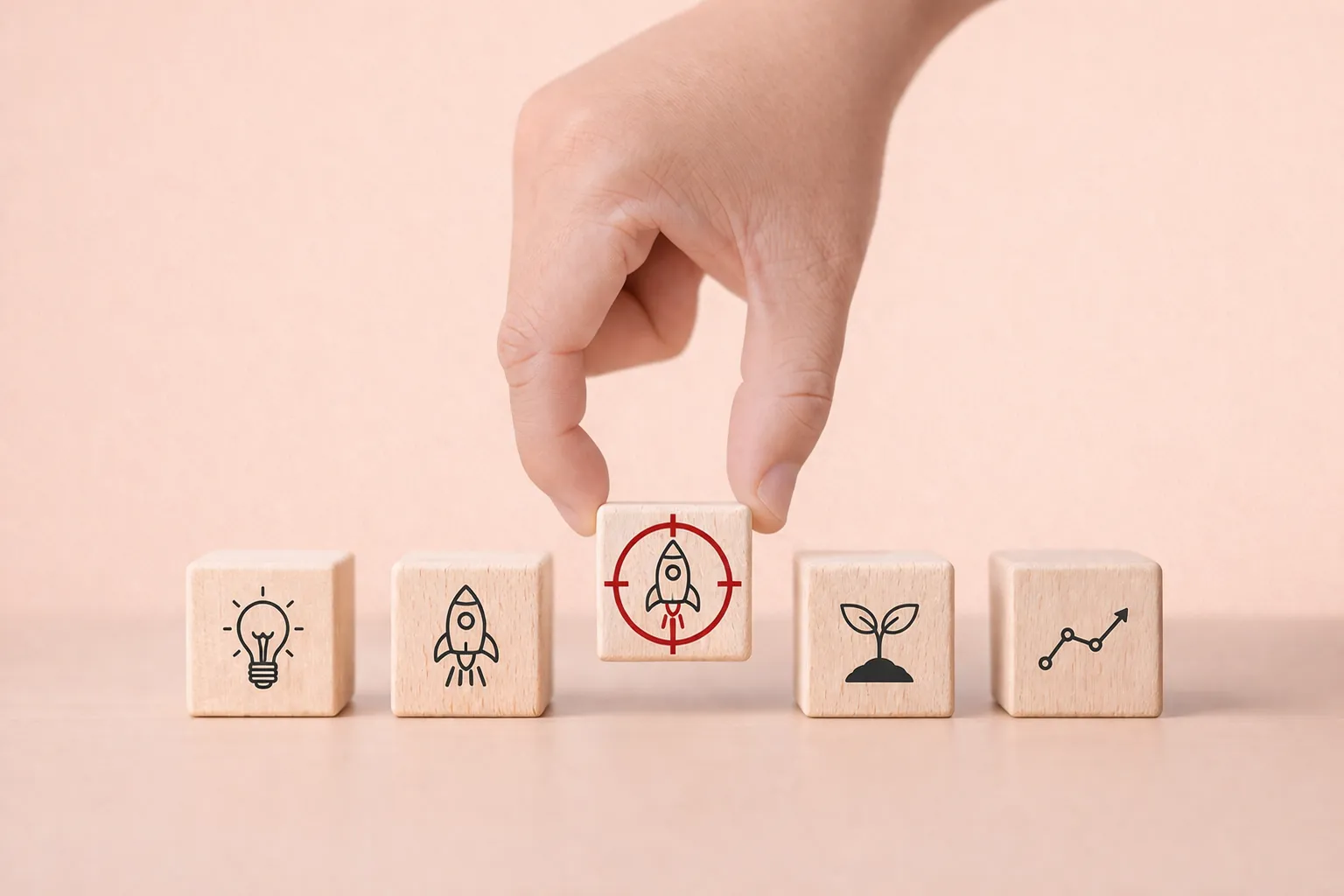 Hand selecting a wooden block with a target icon from a row of blocks