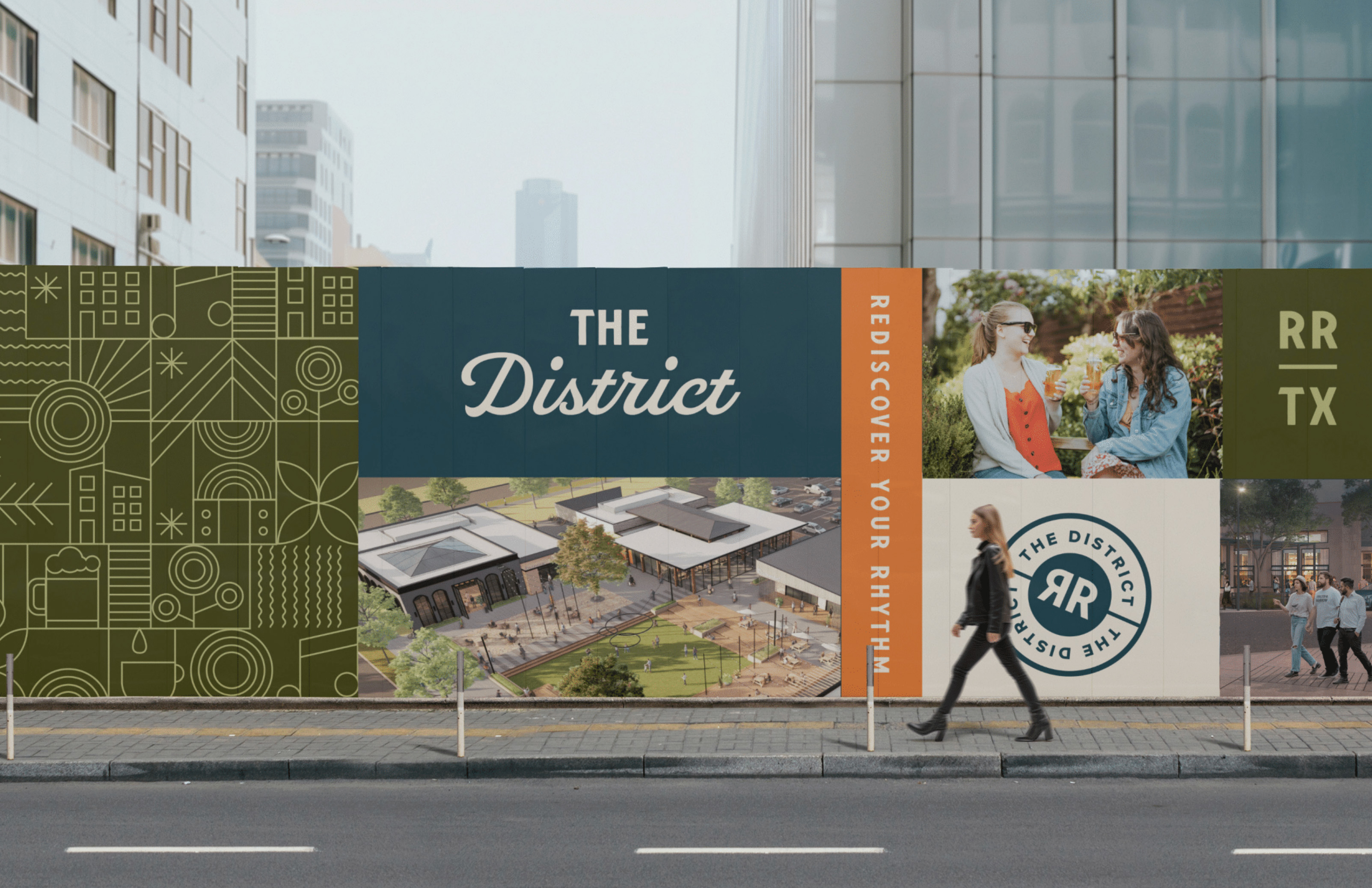 Outdoor banner showing The District development with logo, tagline Rediscover Your Rhythm, and people socializing.
