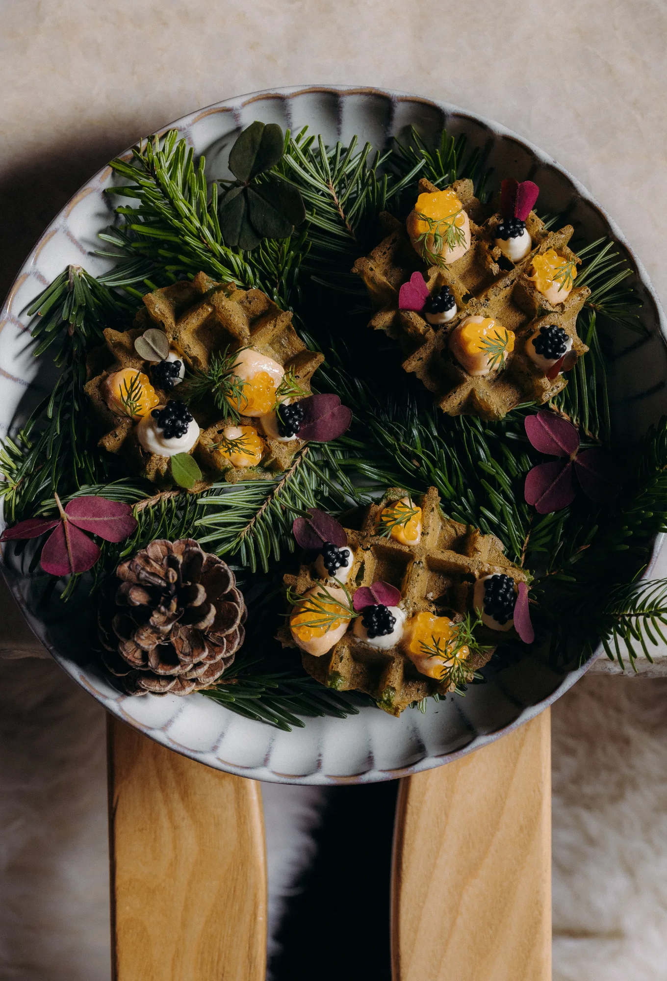 Gourmet plate decorated with edible flowers and greenery at ChaCha restaurant in Megève, Annie Famose Group (AFGroupe).