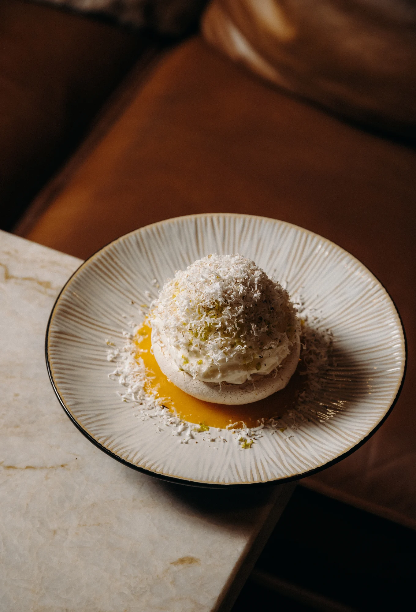 Elegant dome-shaped dessert served on a fruity coulis at ChaCha restaurant in Courchevel, Annie Famose group (AFGroupe).