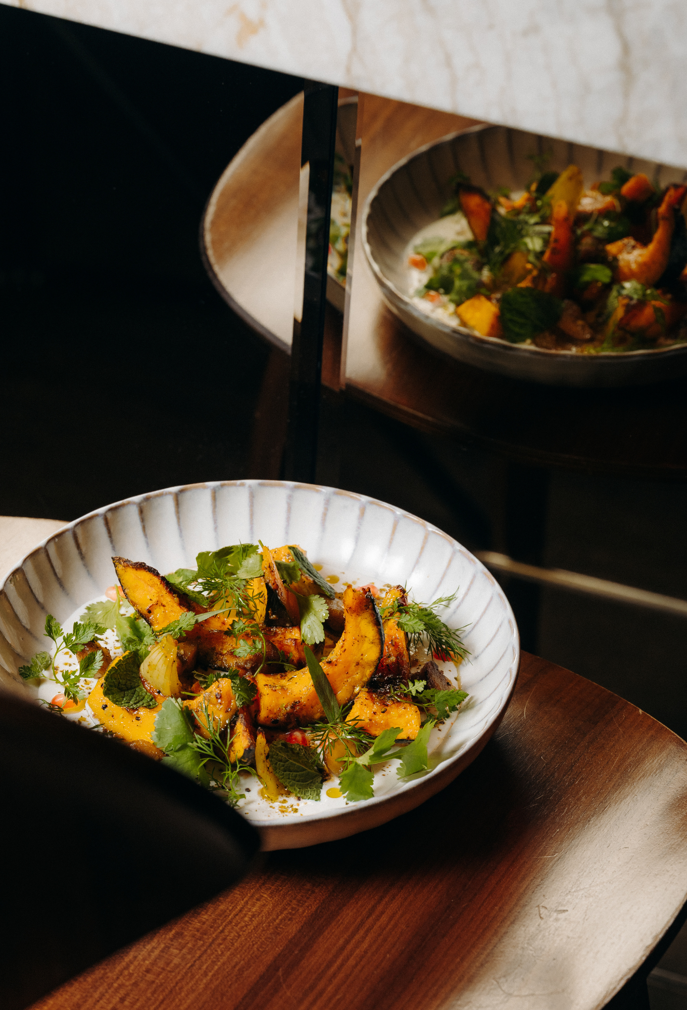 Gourmet dish with vibrant flavors, presented in textured ceramic bowls at the ChaCha restaurant in Courchevel, Annie Famose Group (AFGroup).