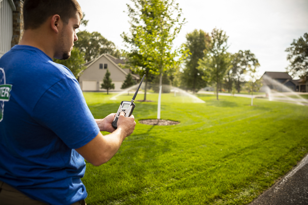 Man using smart irrigation system controller