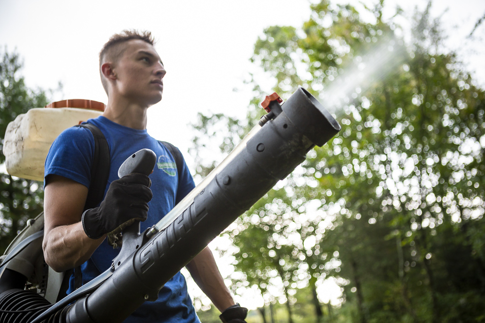 pest control team uses backpack sprayer to kill mosquitoe
