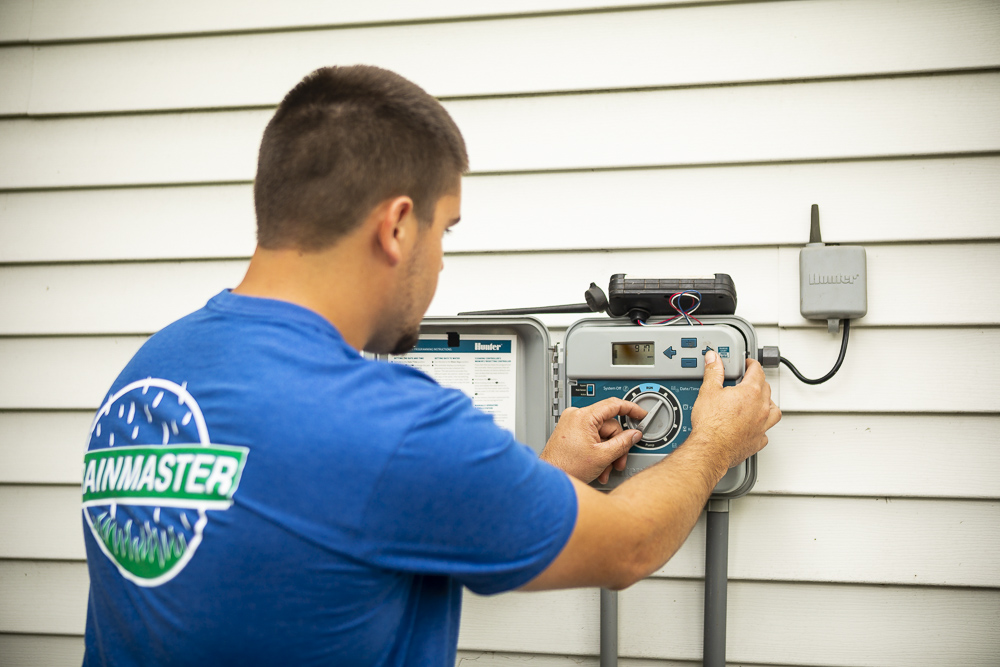 irrigation technician adjusts controller
