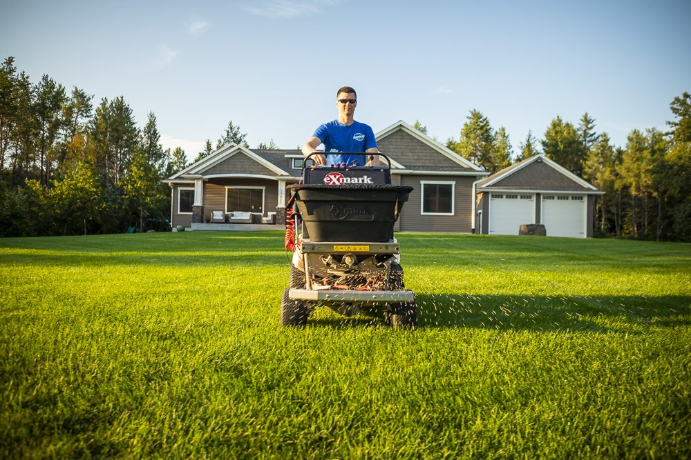 lawn technician applying fertilizer
