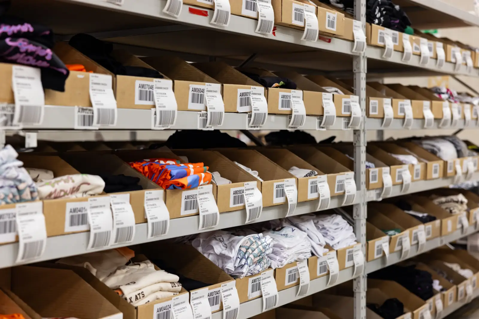 Labelled pick bins of folded apparel SKUs on Fulfilment Australia shelving