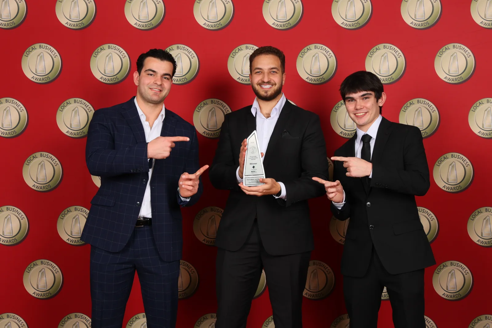 Fulfilment Australia team members pointing to the award