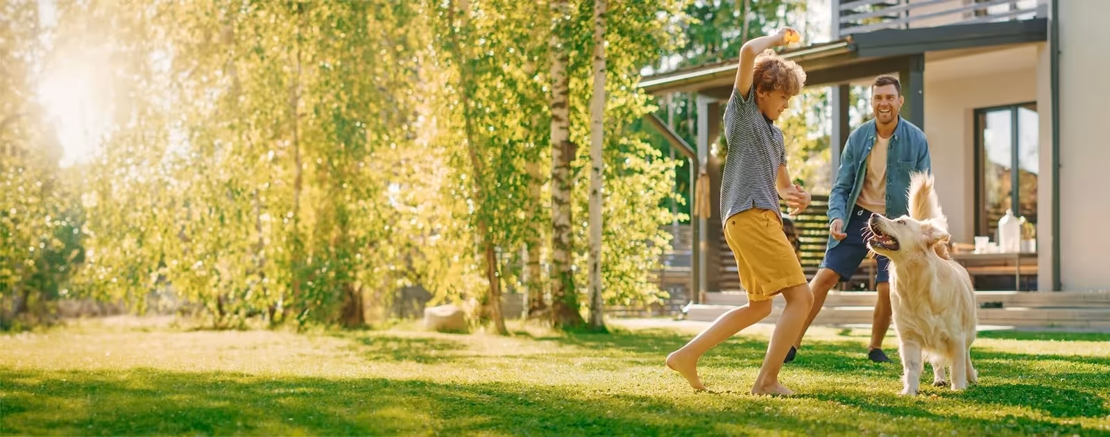 father and son playing on nice lawn