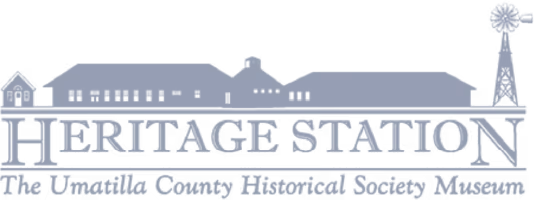 Logo of Heritage Station with stylized building silhouettes and a windmill