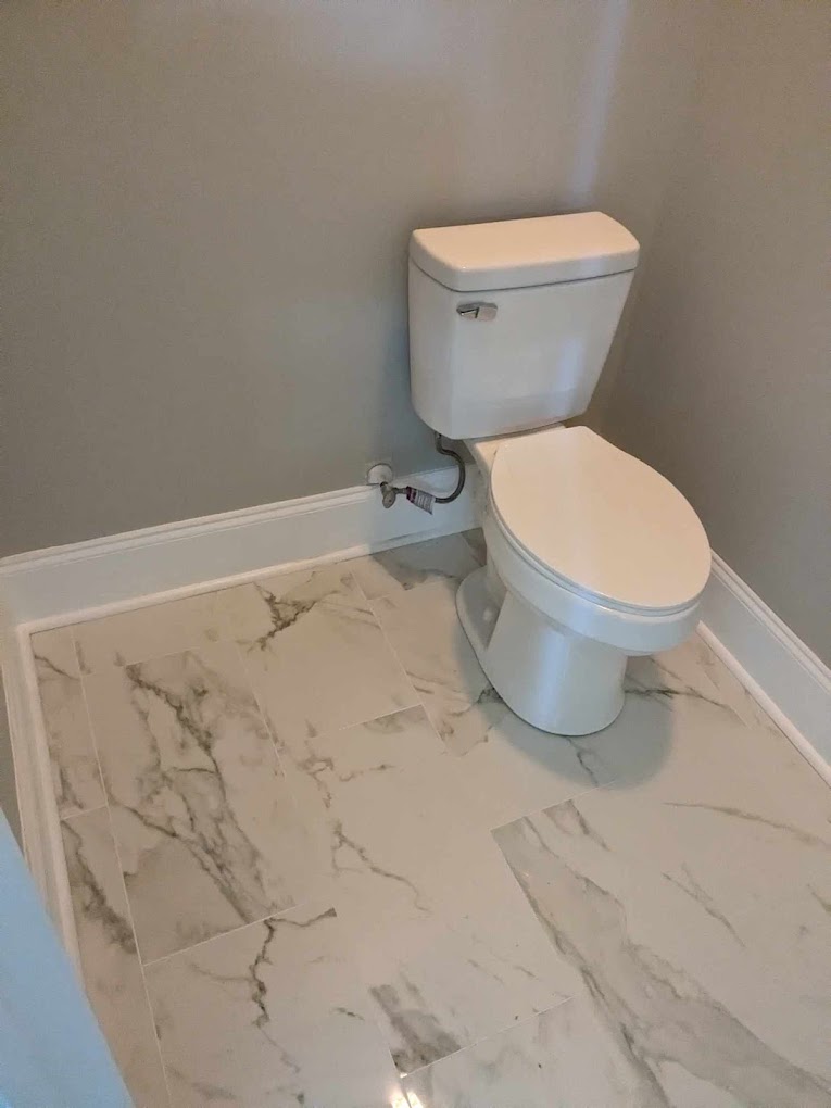 image of plumber working under a sink