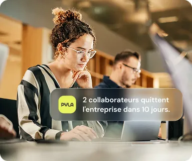 Woman in front of her computer screen, thinking as part of her work.