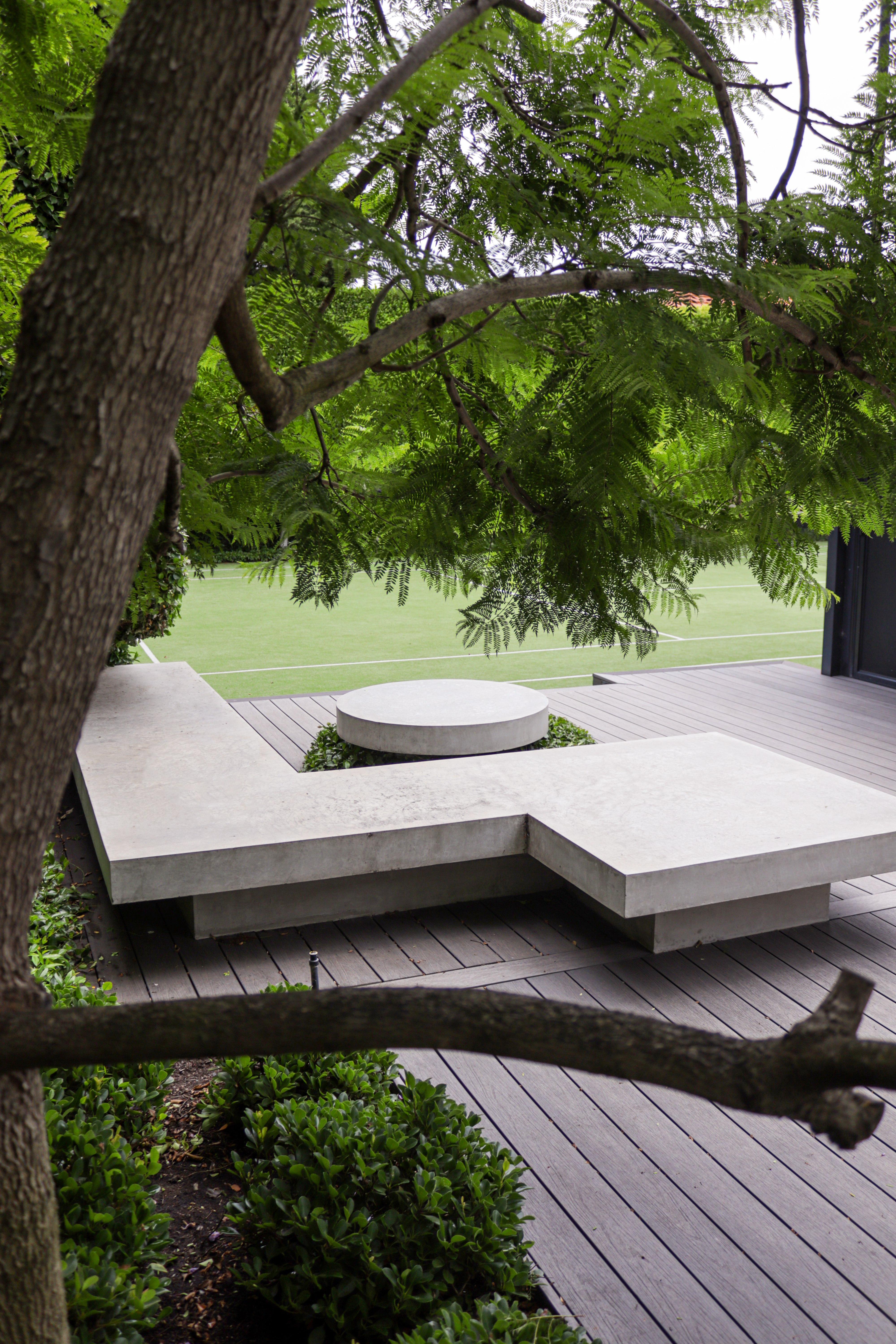 Sculpted concrete on a DVH maintained tennis court and perfect hedges