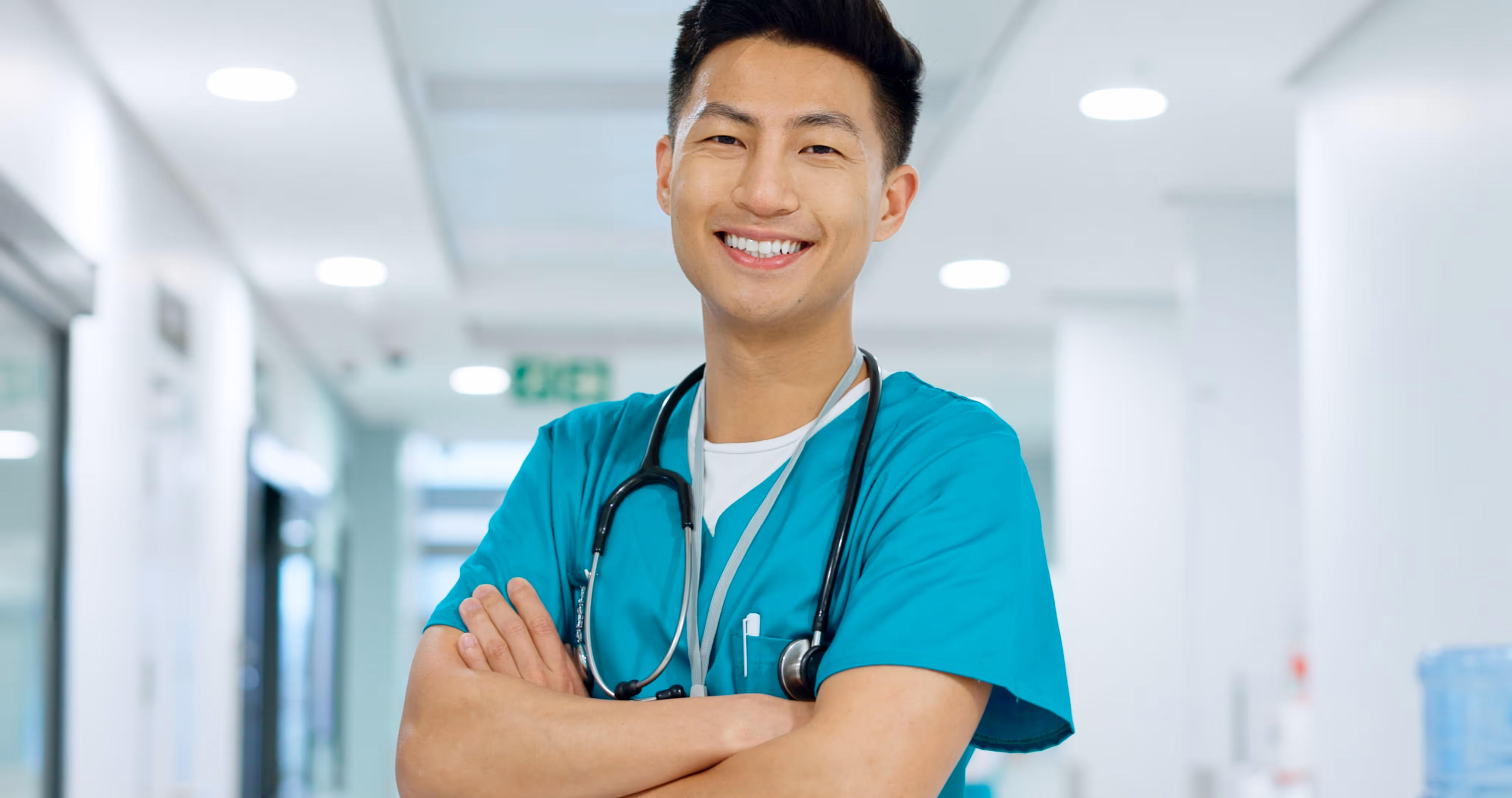 A male doctor smiles looking straight in the camera