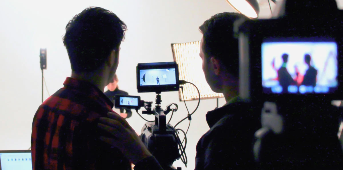 people watching a camera