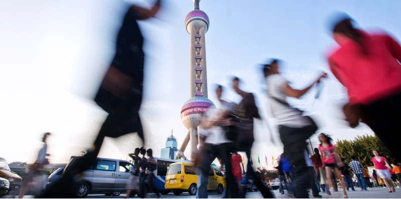 people walking in front of a land mark 