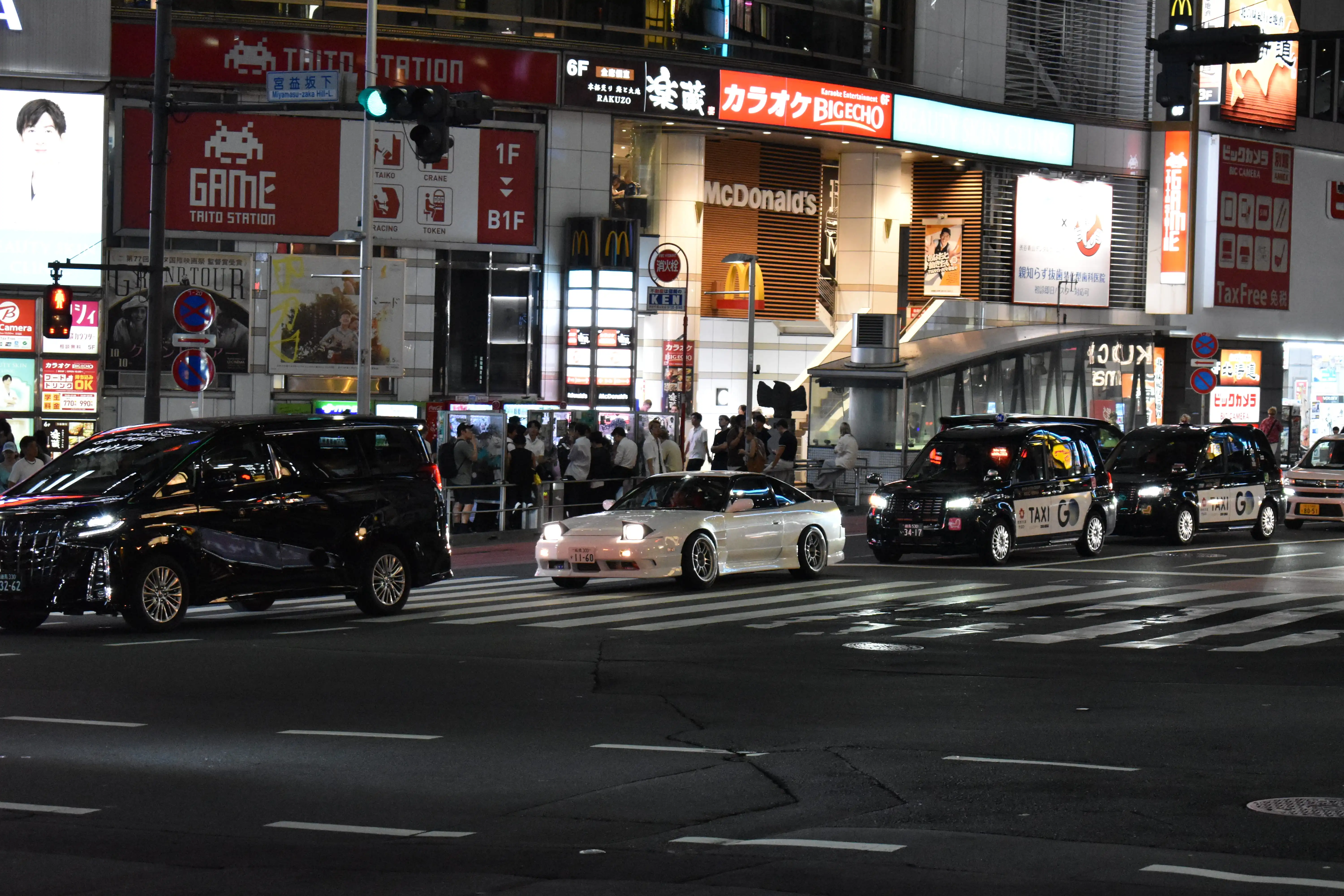 Night street scene in Shibuya Tokyo,  Japan, a white sports car with pop-up headlights, and illuminated signs, this is the vibe of Pineworks.