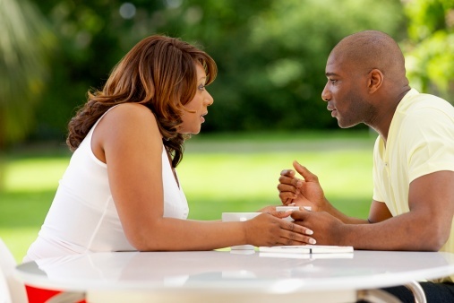 Couple_sitting_outdoor_table_talking