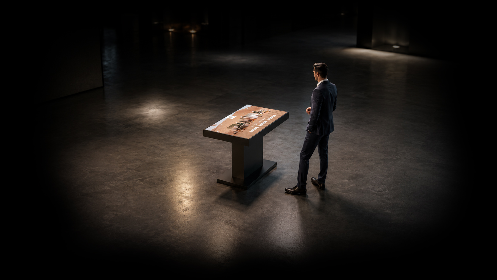 A man standing infront of interactive touch table