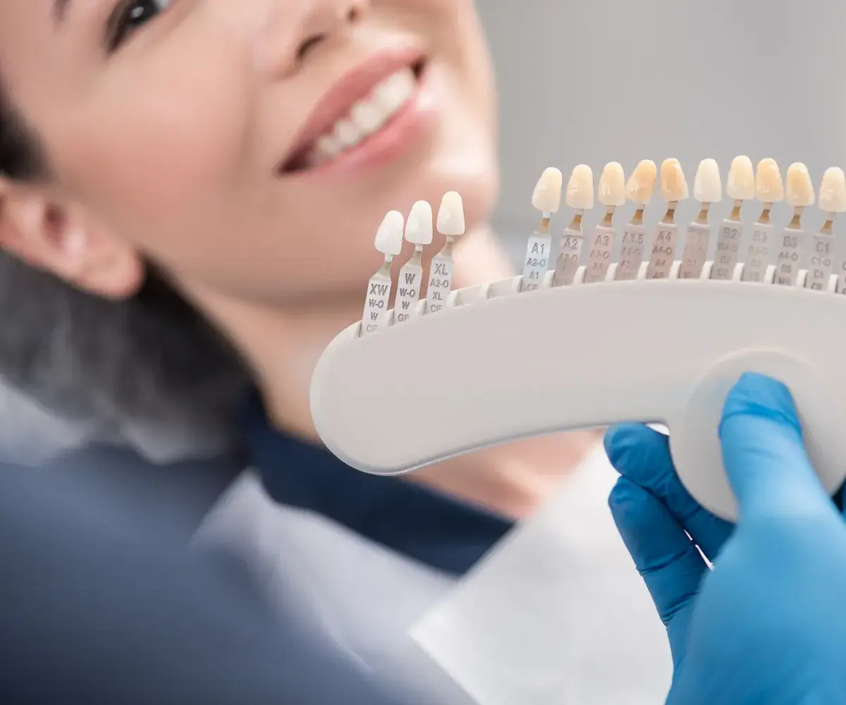 A woman holding a toothbrush in her hand.