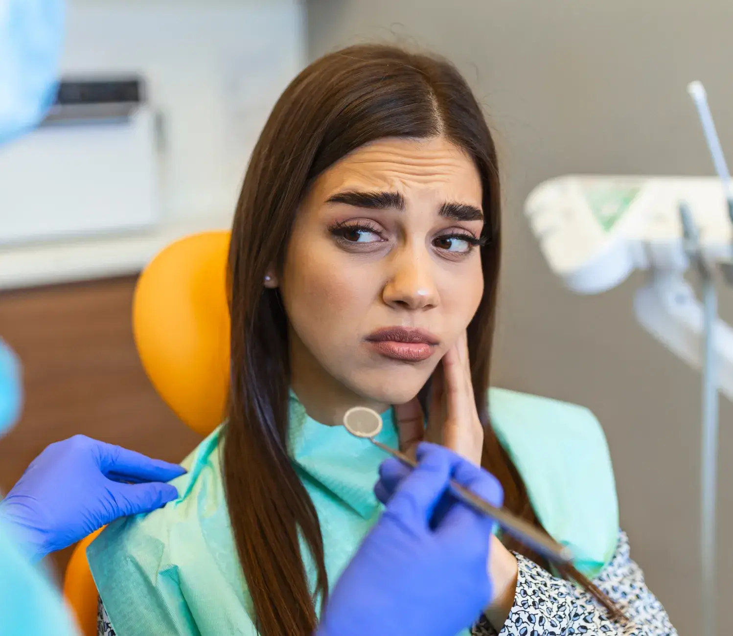 A woman getting her teeth checked by a dentist.