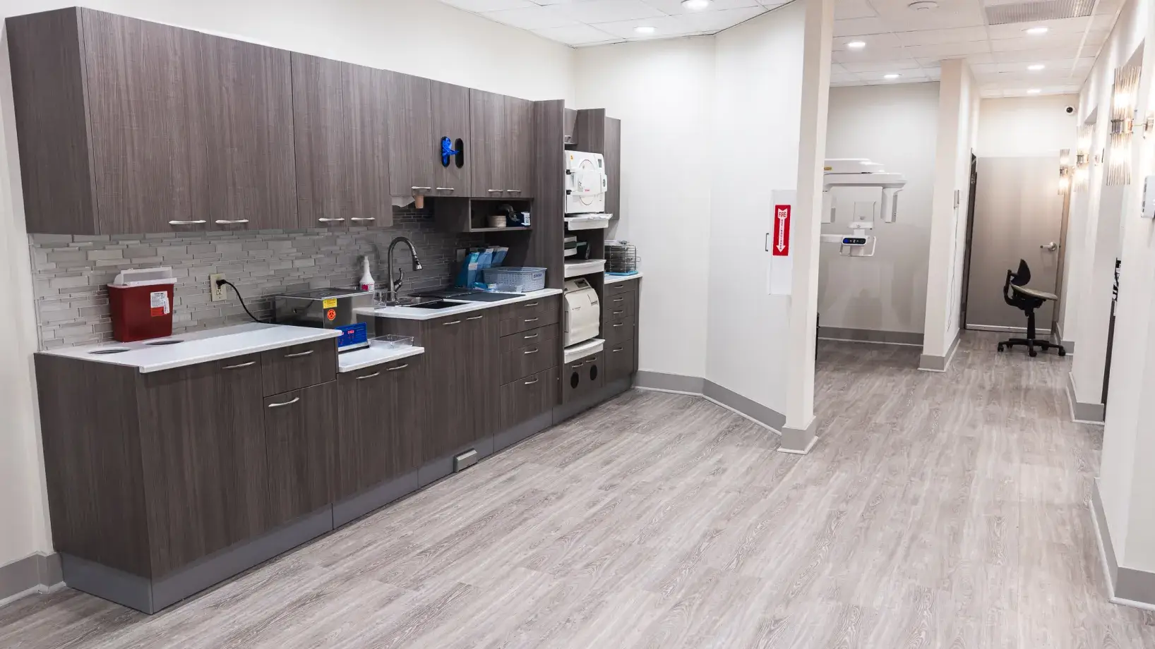 A kitchen area with a sink, stove and refrigerator.