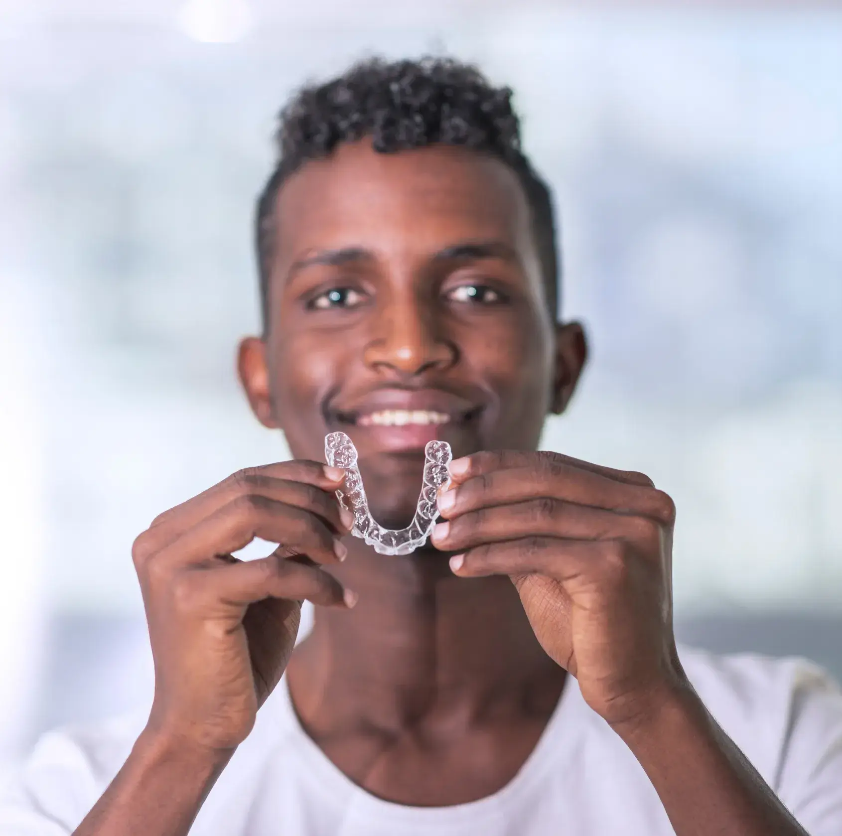 A man holding a toothbrush in front of his mouth.