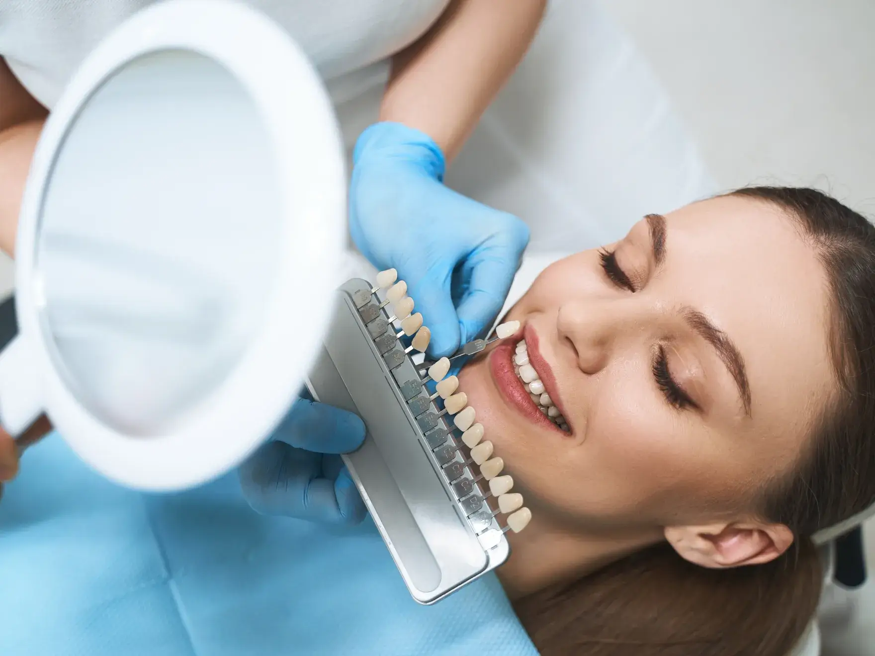A woman getting her teeth checked by a dentist.