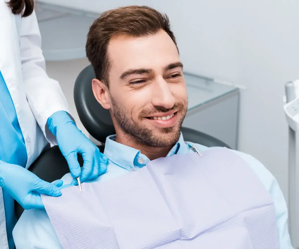 a man getting his teeth checked by a dentist