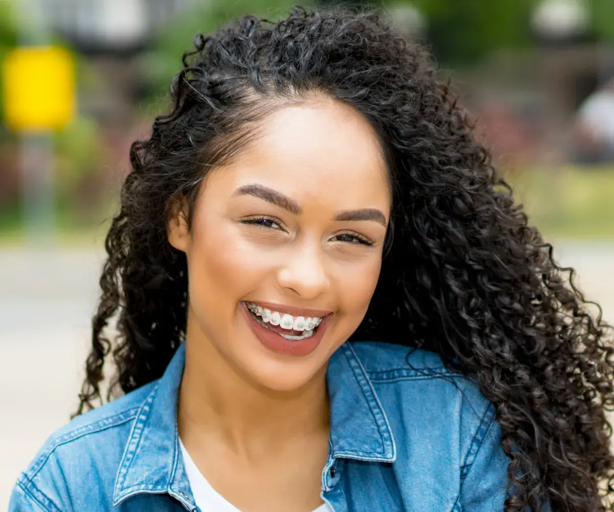 Woman smiling outside.