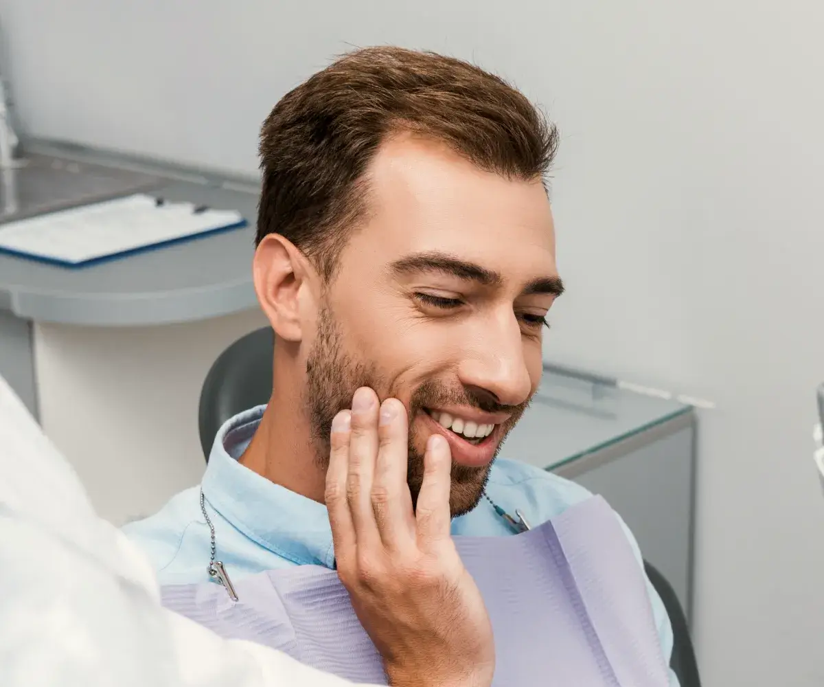 Man touching his face.