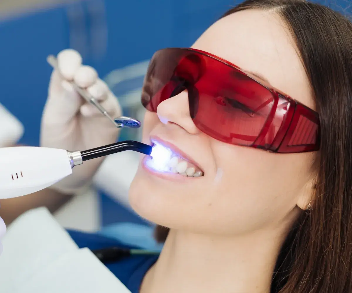 woman with glasses in dentist chair