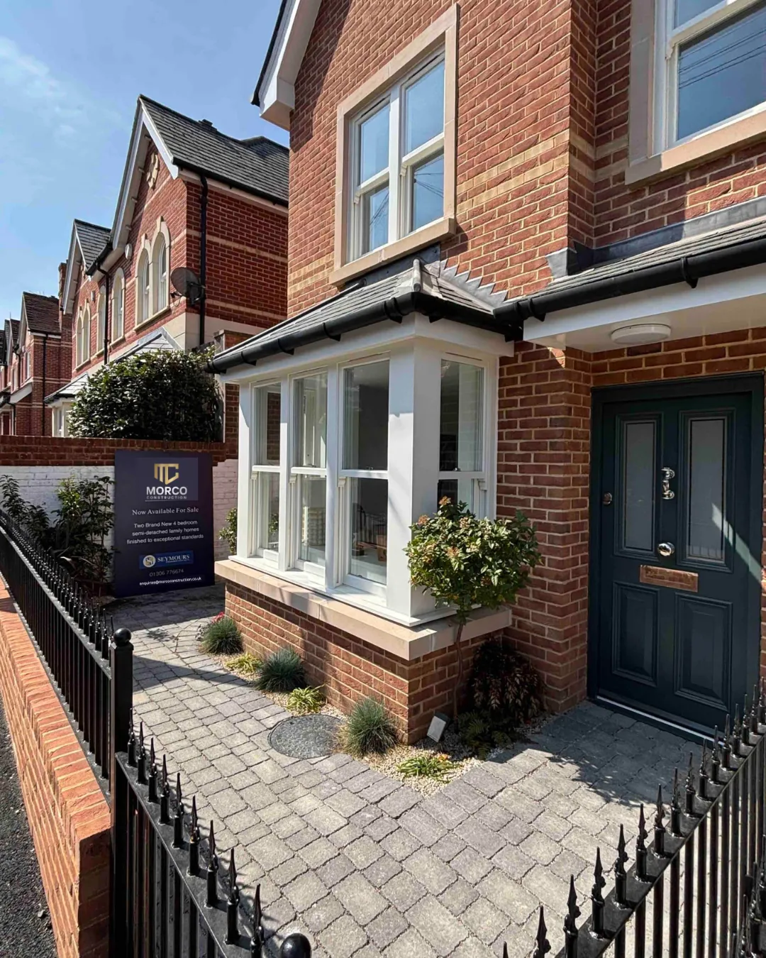 A red-brick Victorian semi in Surrey renovated by Morco, with a Morco board outside