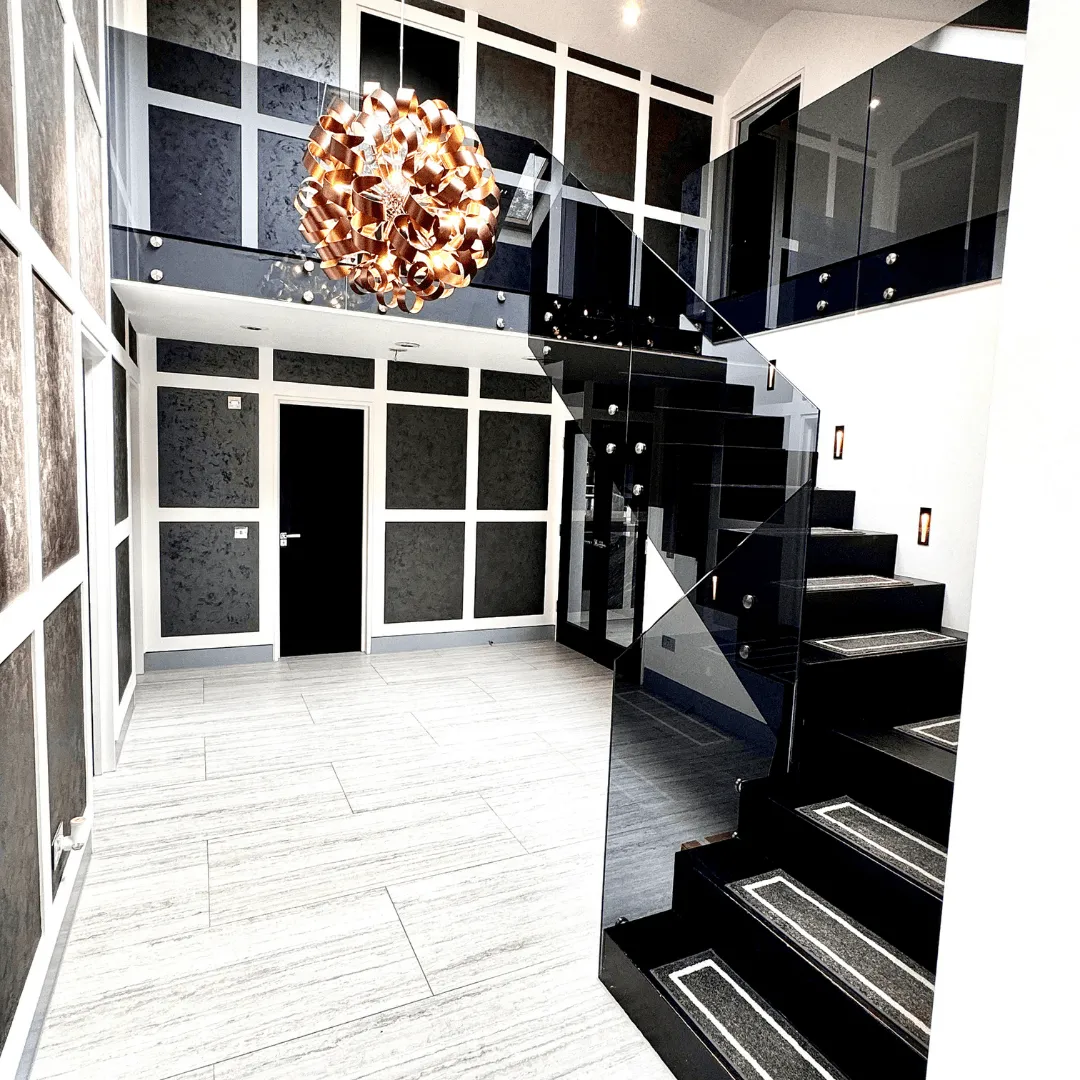 Finished hallway with glass staircase