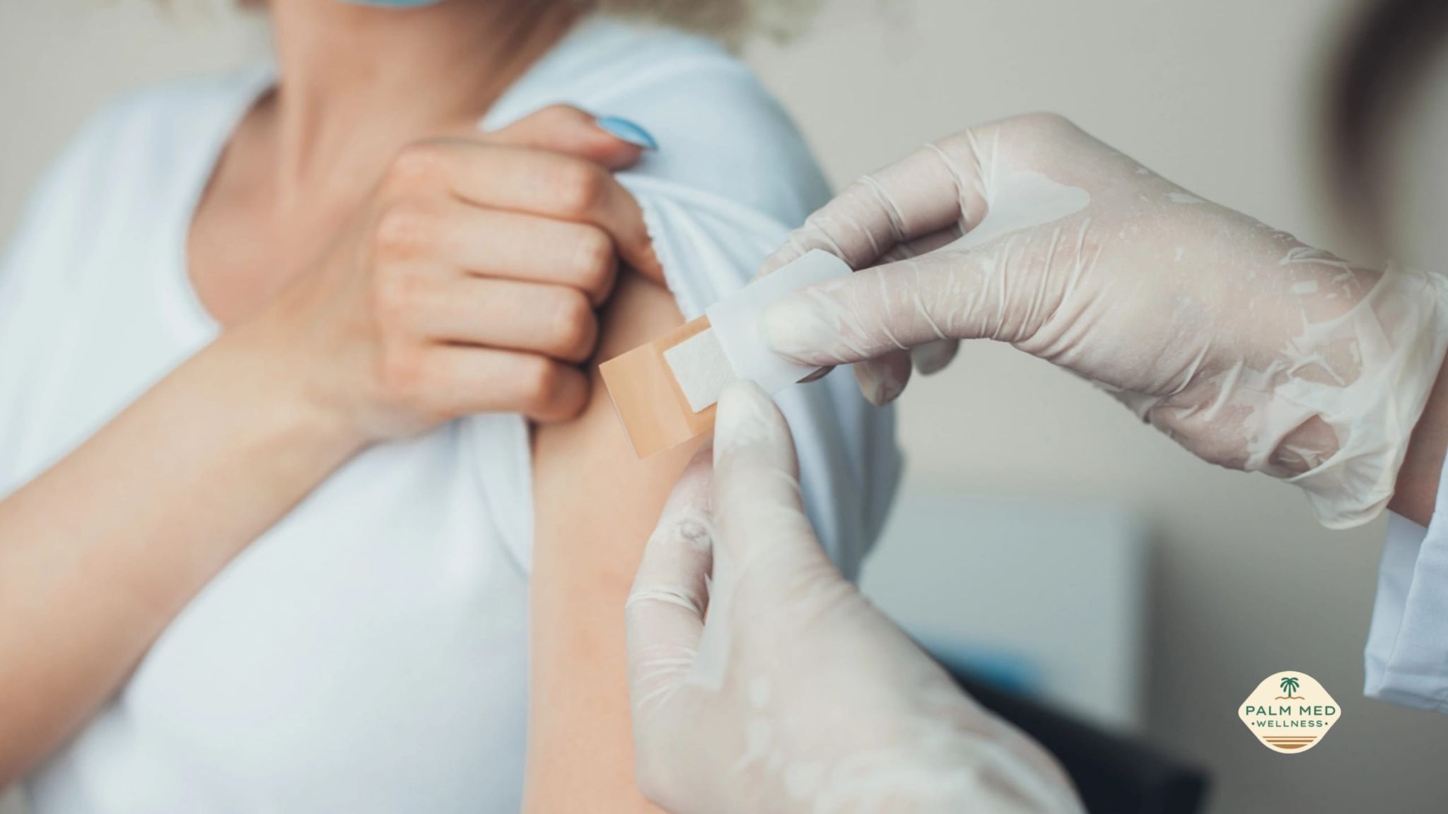 A healthcare professional gives a vaccine to a woman, who appears relaxed during the process.