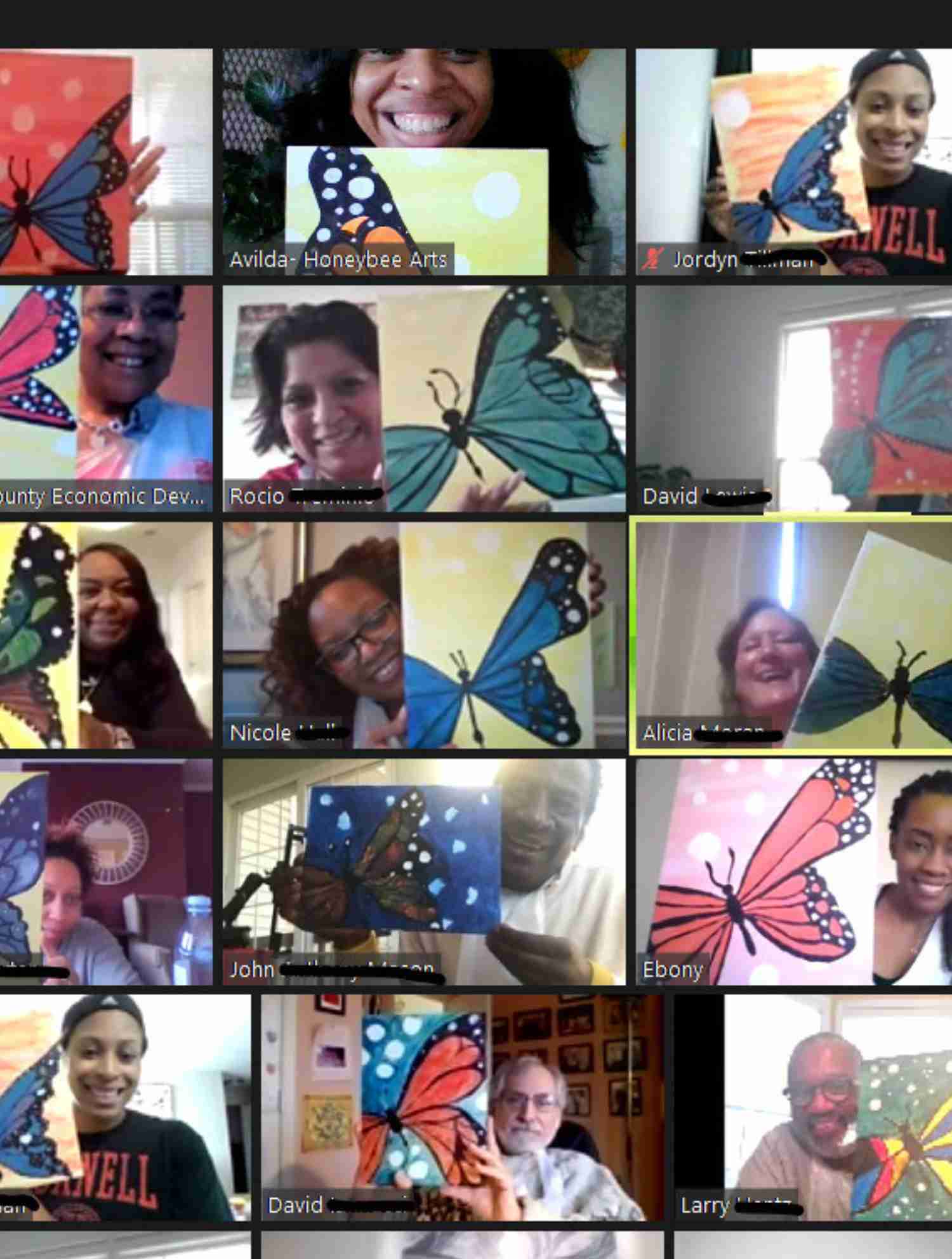 Zoom call gallery showing multiple people smiling and holding colorful butterfly paintings.