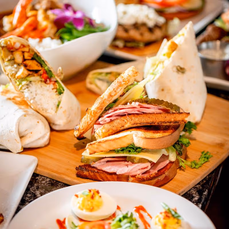 A plate of food with a sandwich and eggs.