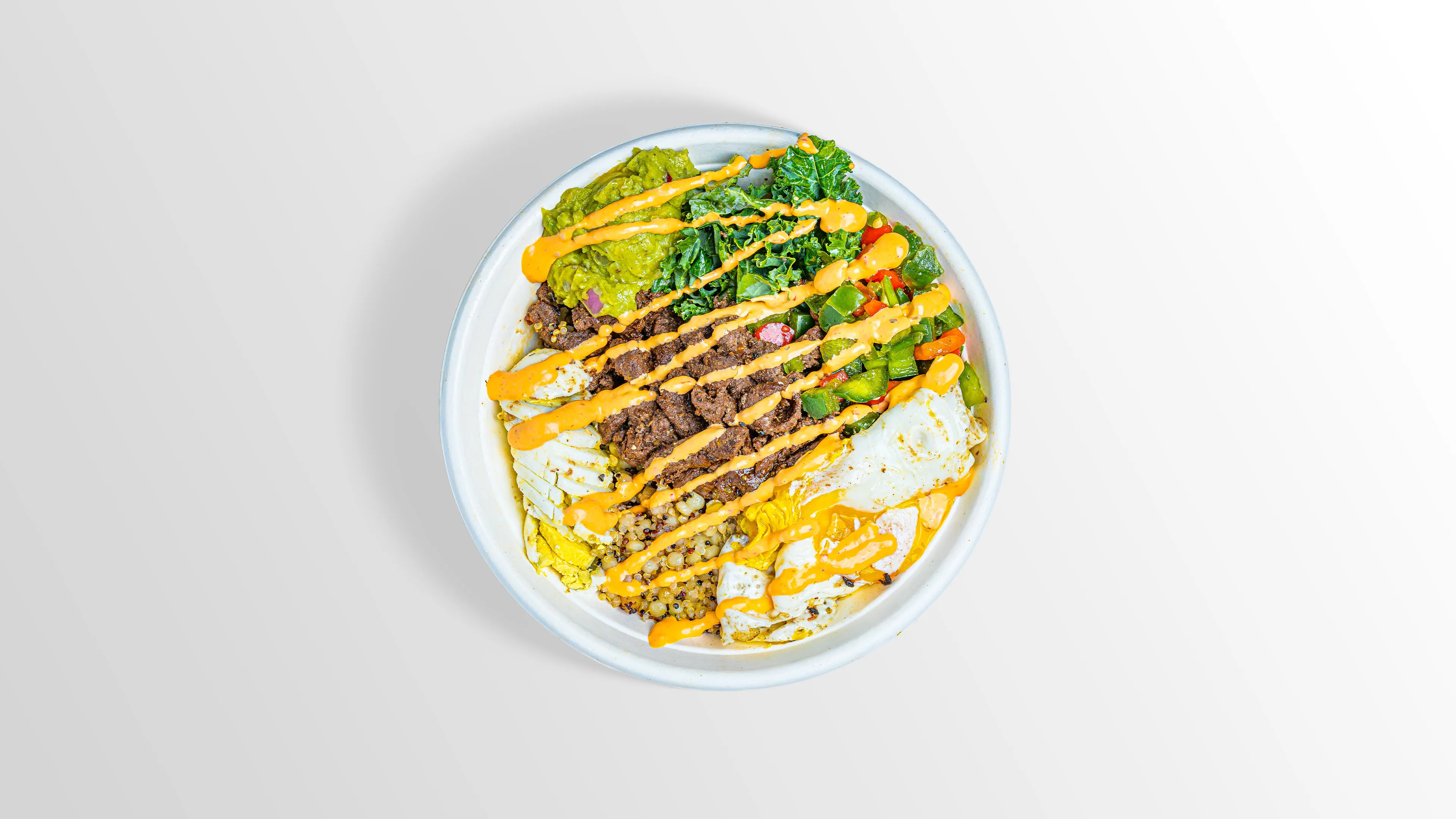 Brunch Bowl with two eggs, steak, quinoa, kale and guacamole