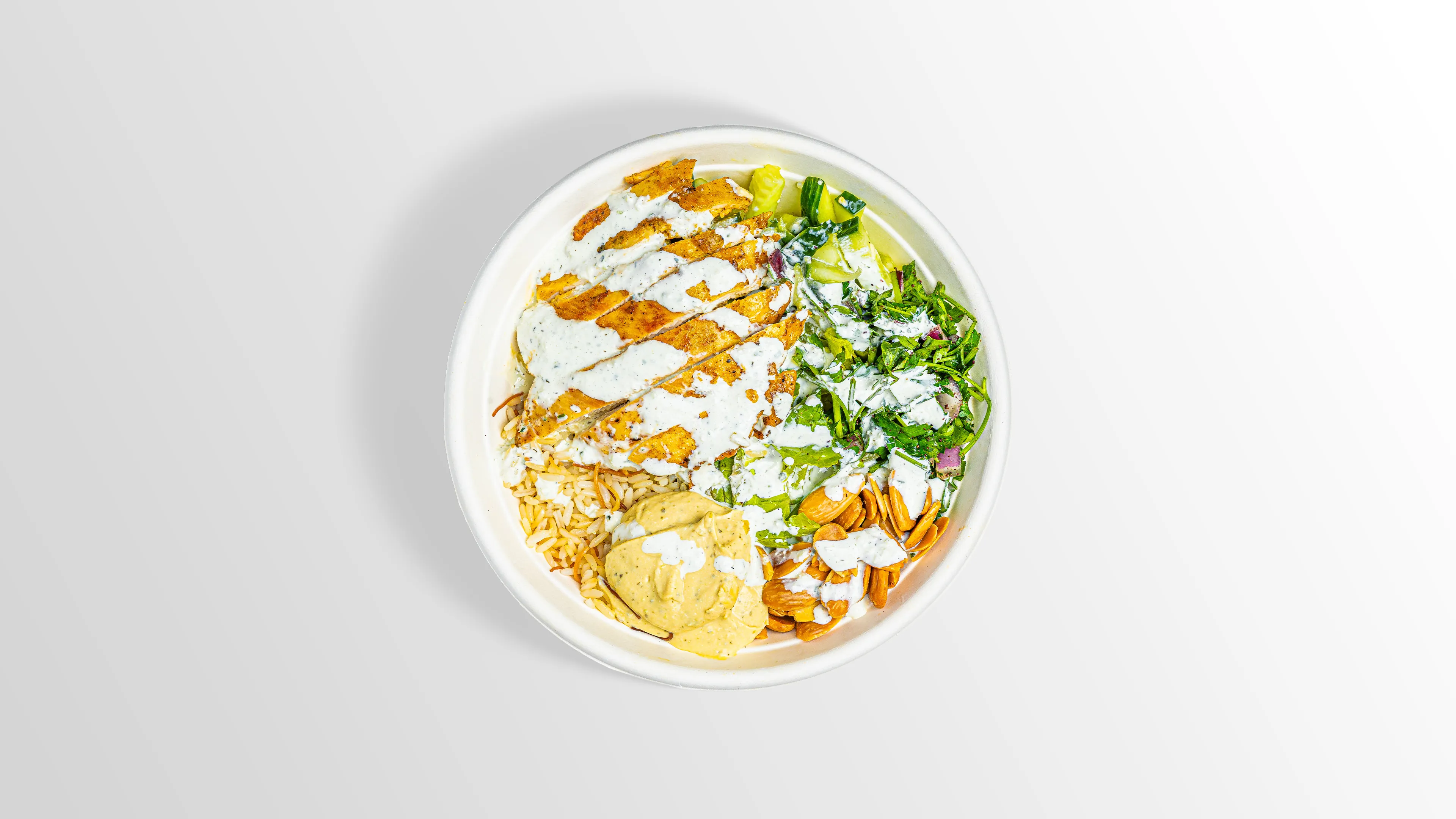 Chicken Bowl with pesto hummus, white rice, fattoush and roasted almonds