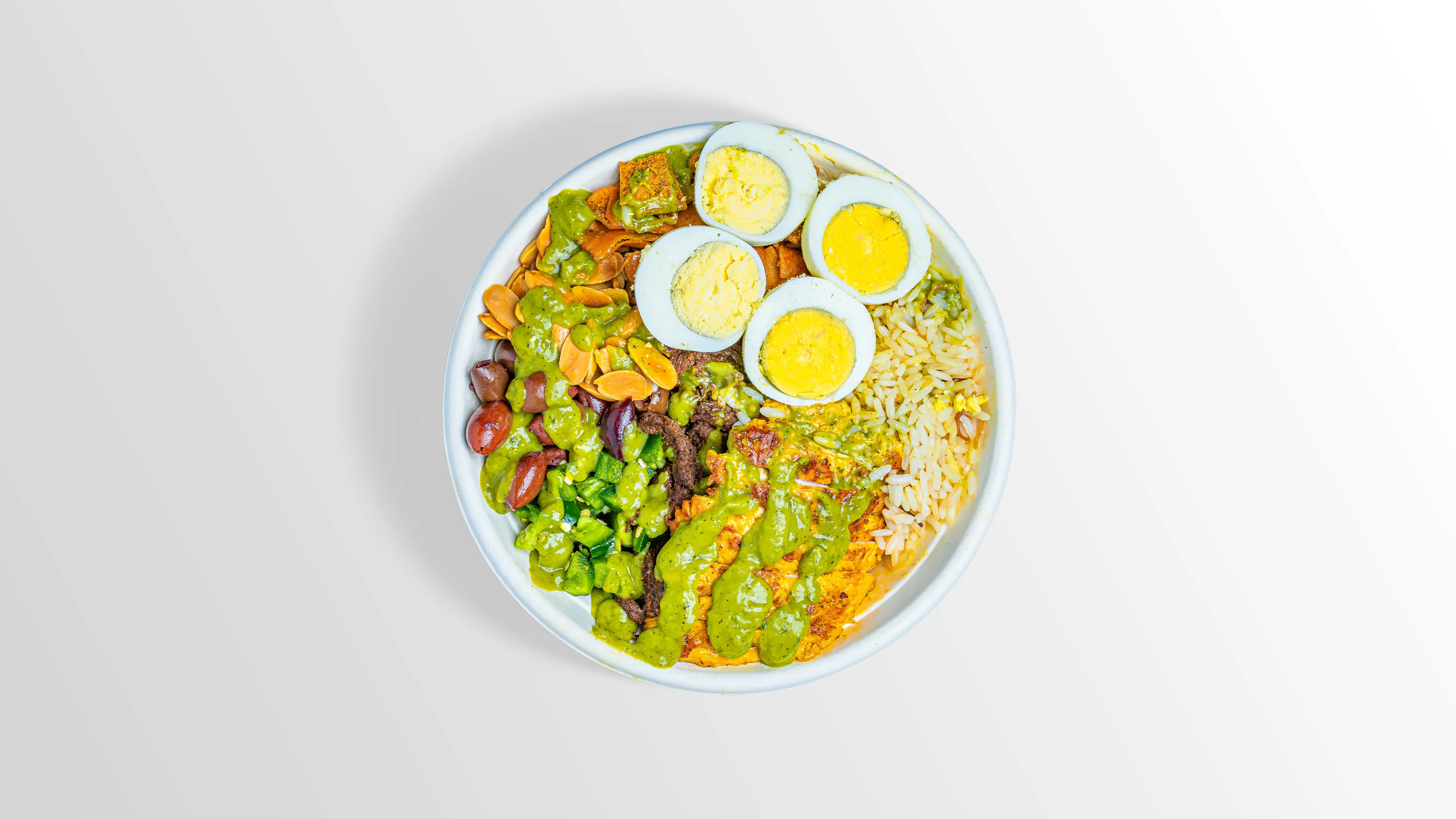 The Body Builder Bowl with chicken, steak, egg, white rice and spicy guac sauce