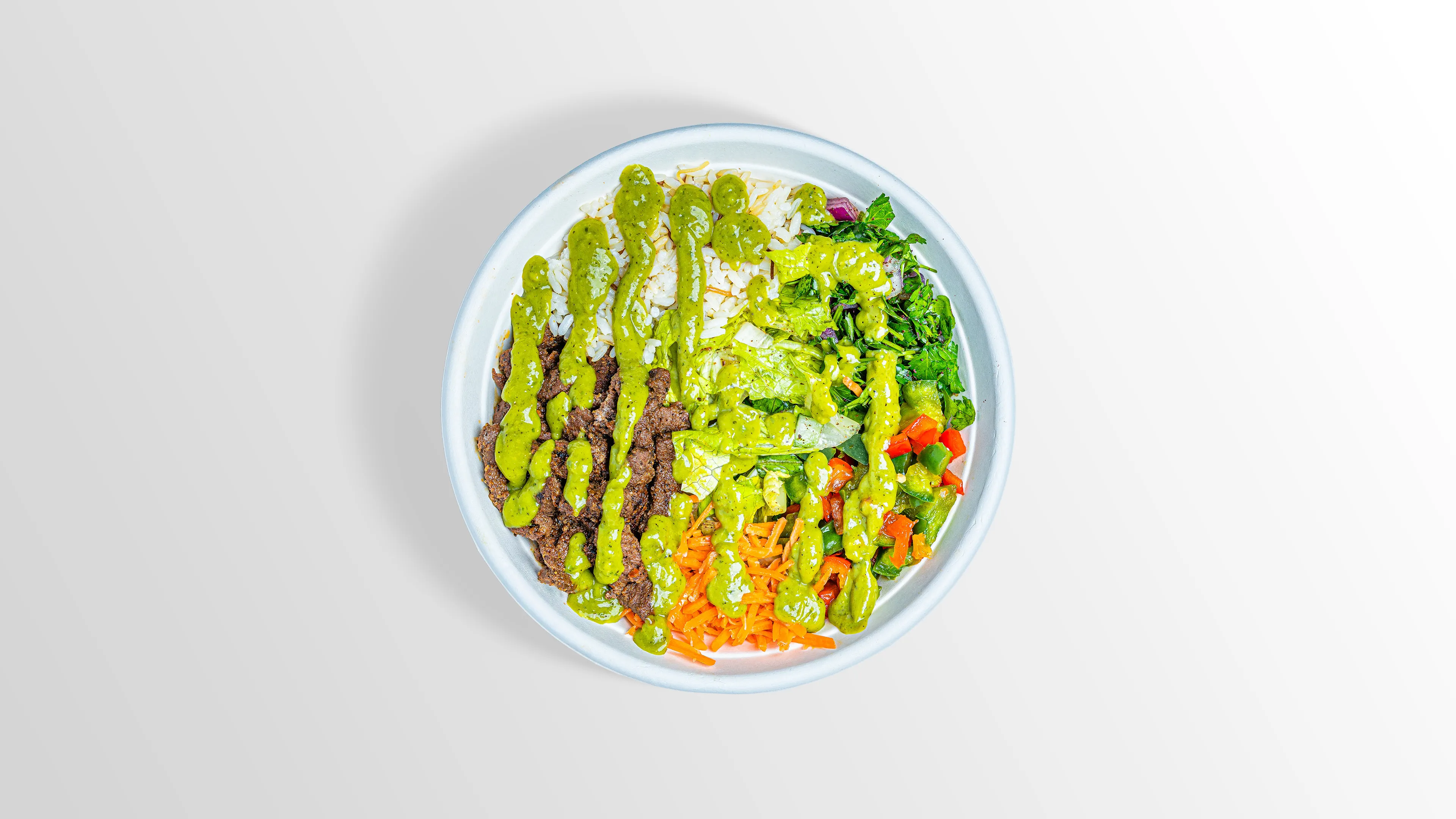 Steak Bowl with spicy hummus, white rice, fattoush and spicy guac sauce