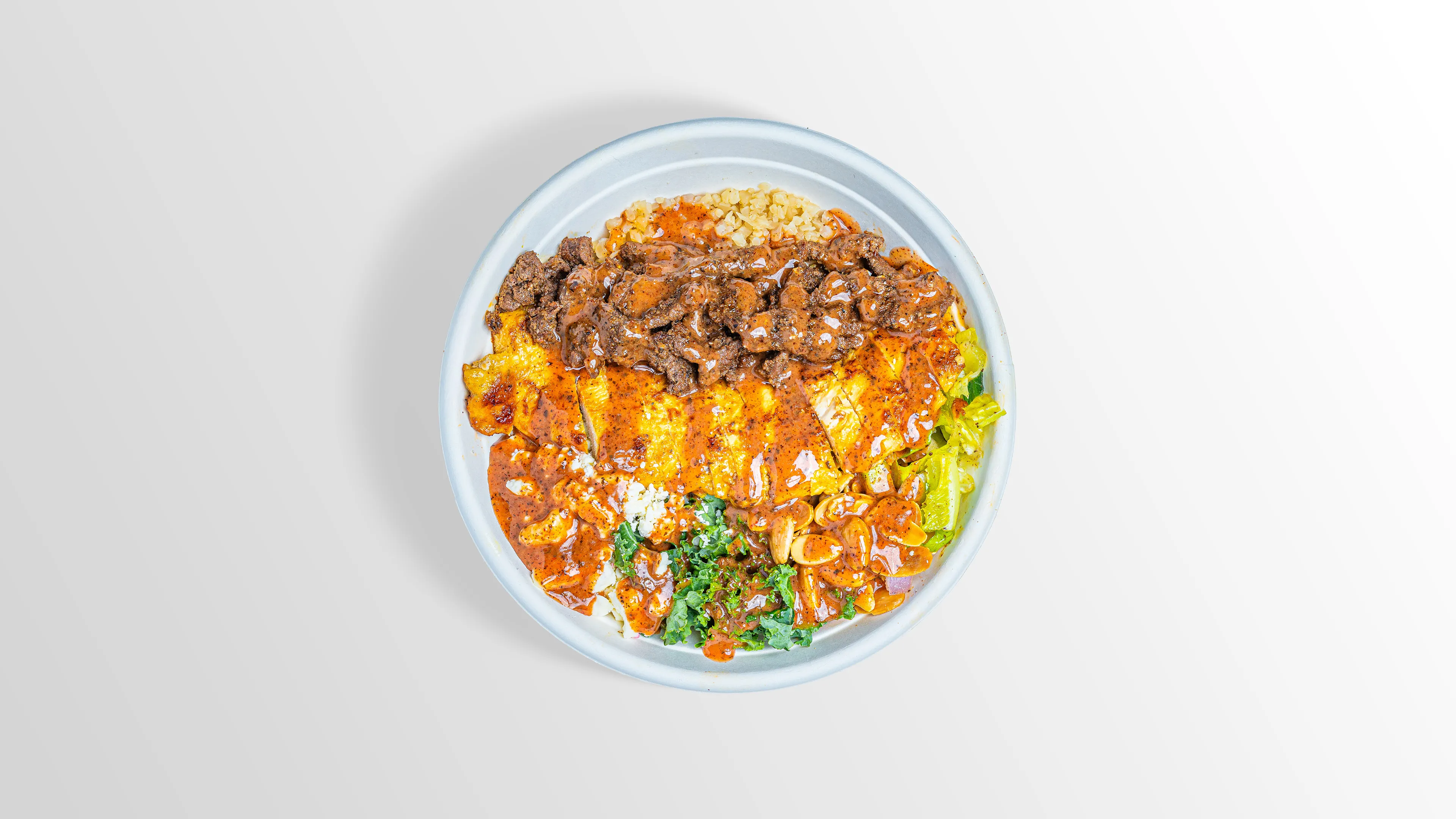 Keto Bowl with cauliflower rice, steak, chicken, kale and feta
