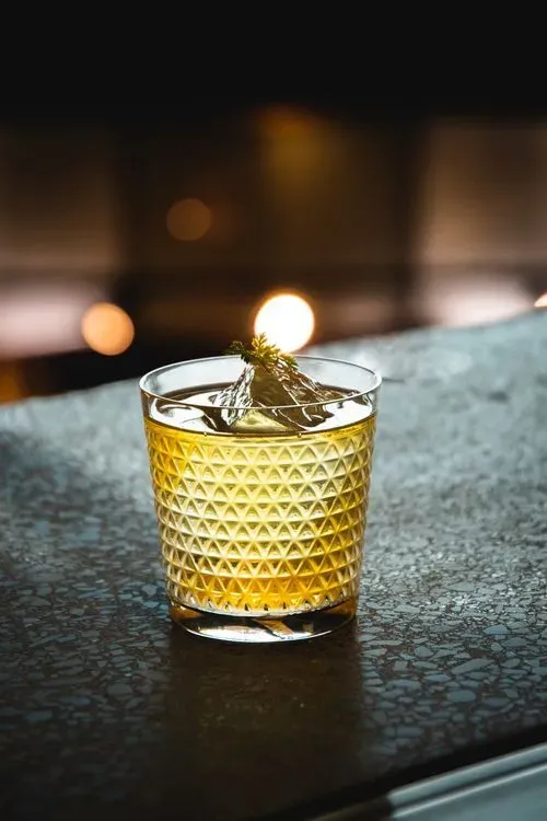 A small glass with a candle inside of it