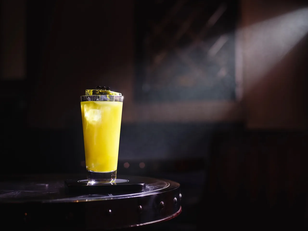 A glass of orange juice sitting on top of a table