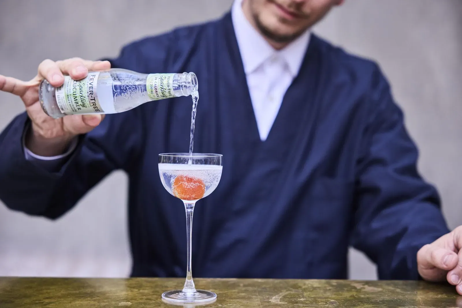 A man pouring a drink into a glass