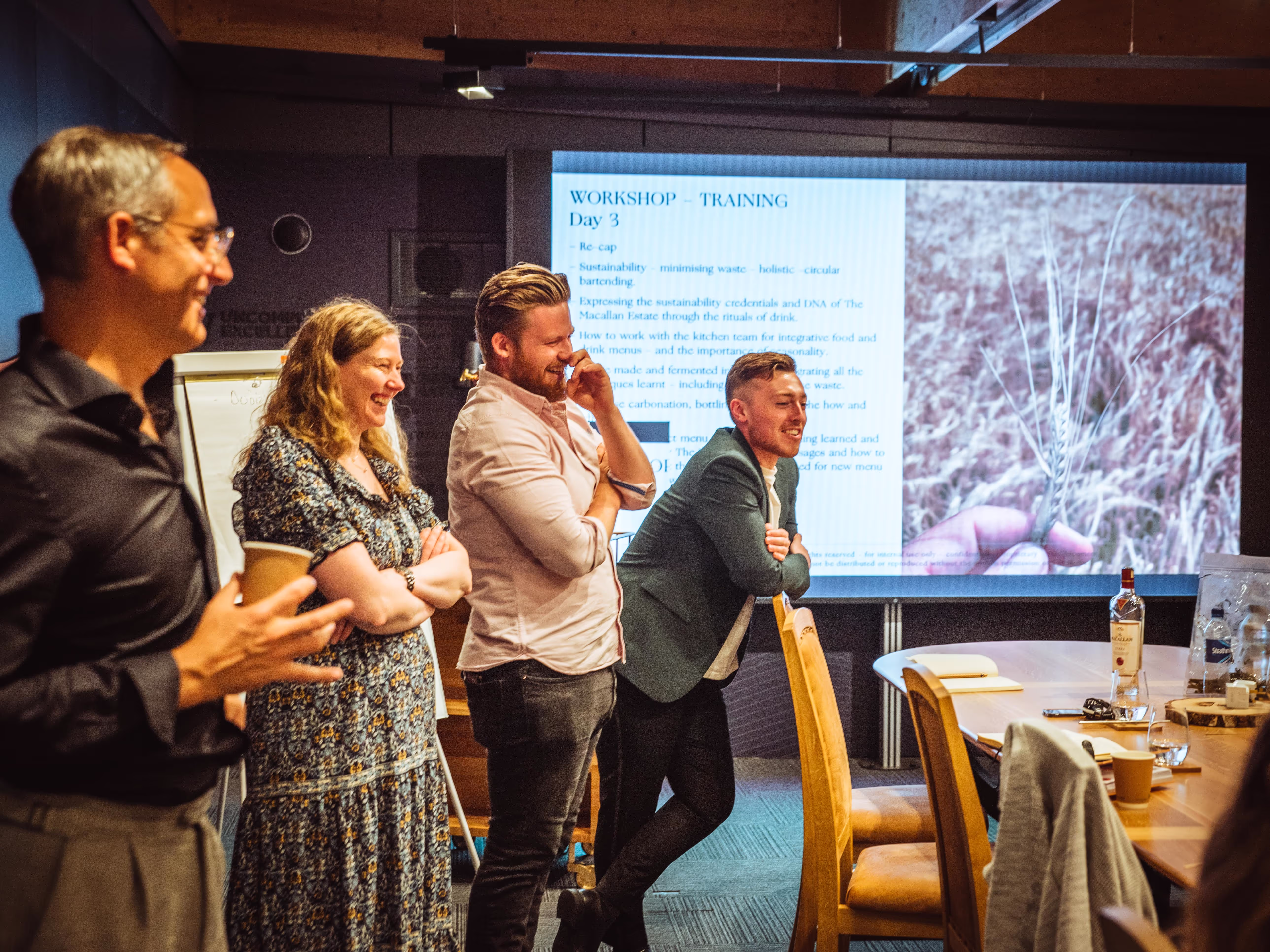 People gathered around a table, laiughing and talking to each other