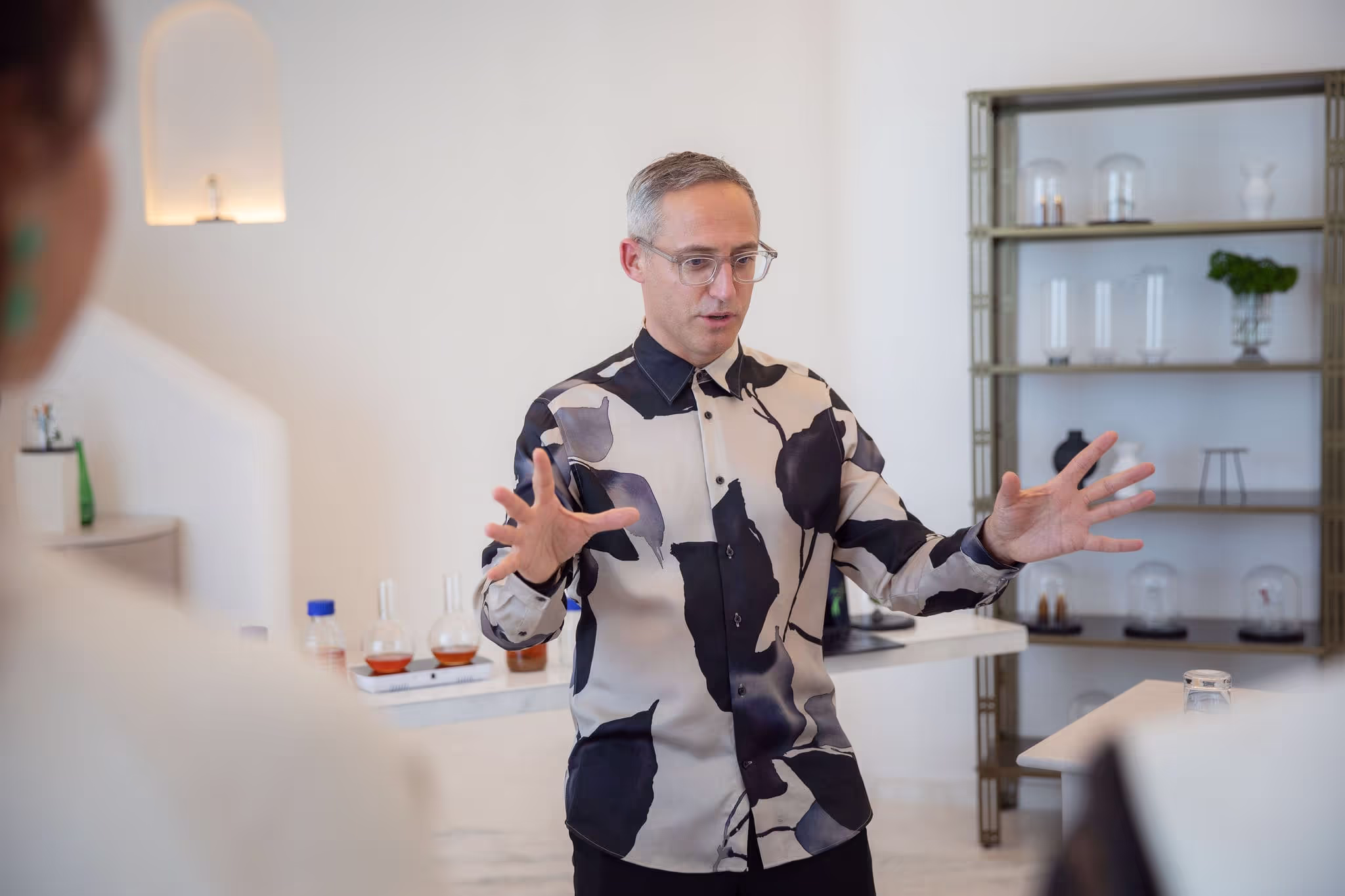 A man standing in front of a mirror holding his hands out